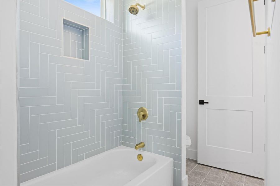 Full bathroom with shower / washtub combination and tile patterned flooring Full bathroom with shower / washtub combination and tile patterned flooring