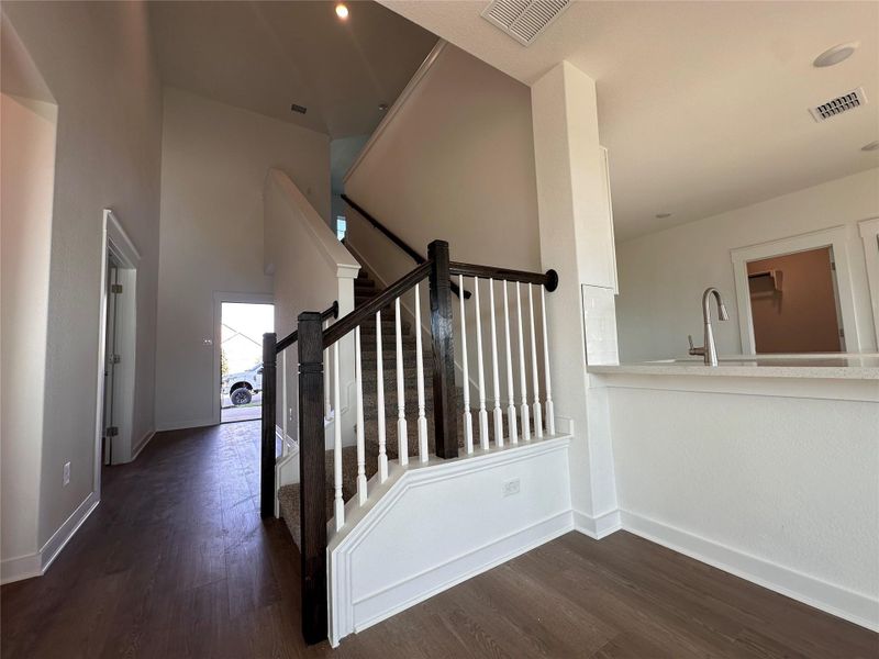 Staircase with wood finished floors and a high ceiling Staircase with wood finished floors and a high ceiling