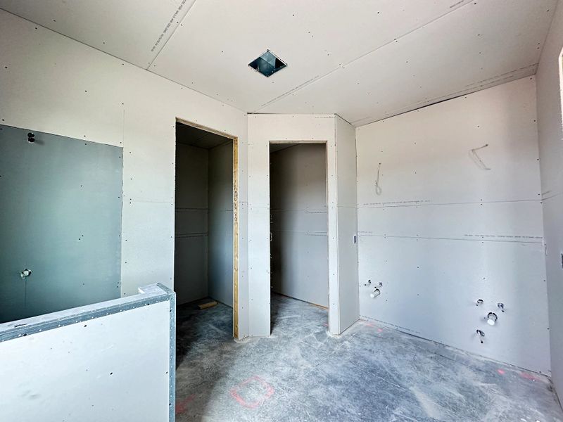 Primary bathroom will feature two sinks, large closet and shower - under construction