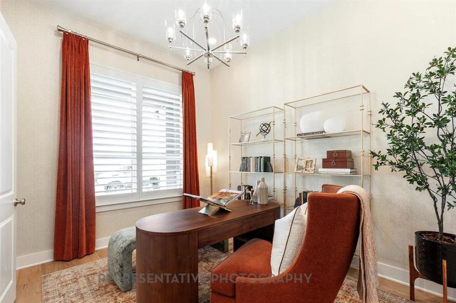 Office area with wood finished floors and a chandelier