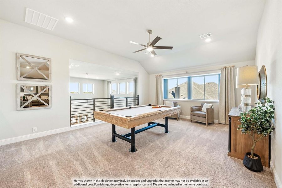 Upstairs game room with air hockey table, carpet flooring, ceiling fan, and open loft railing overlooking lower level.