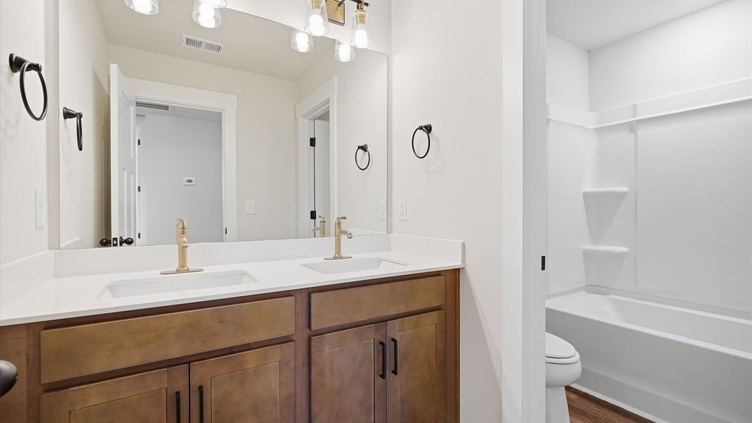 Top-notch bathroom with current fixtures, tasteful materials, and elevated charm at the Harrier Point community Top-notch bathroom with current fixtures, tasteful materials, and elevated charm at the Harrier Point community
