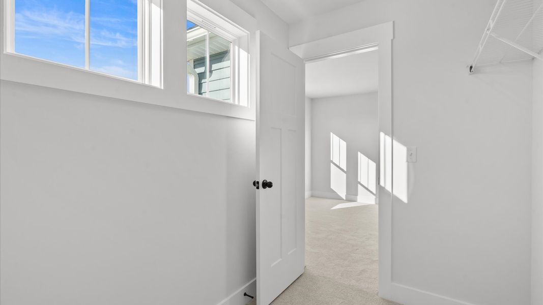 Inviting bedroom with tasteful finishes and large windows that create a fresh, open ambiance Inviting bedroom with tasteful finishes and large windows that create a fresh, open ambiance