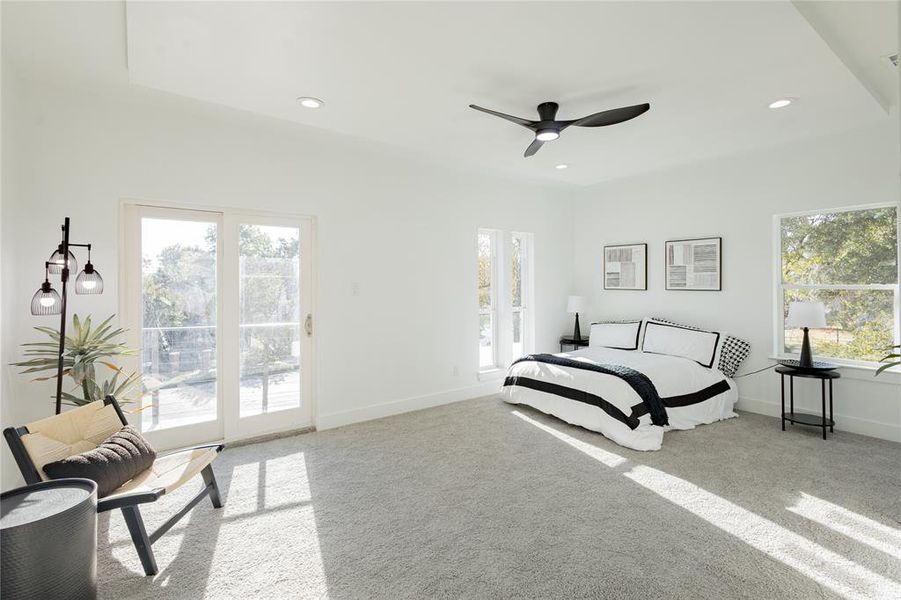 Bedroom featuring light colored carpet, recessed lighting, ceiling fan, and access to Private patio Bedroom featuring light colored carpet, recessed lighting, ceiling fan, and access to Private patio