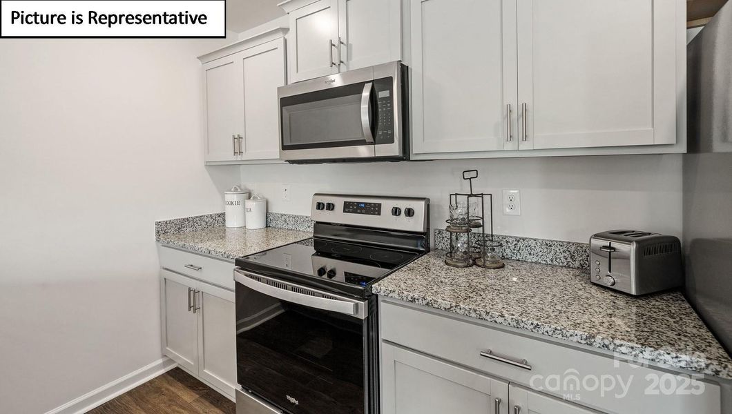 Shaker cabinets, granite countertops, stainless steel appliances for microwave, dishwasher and range included