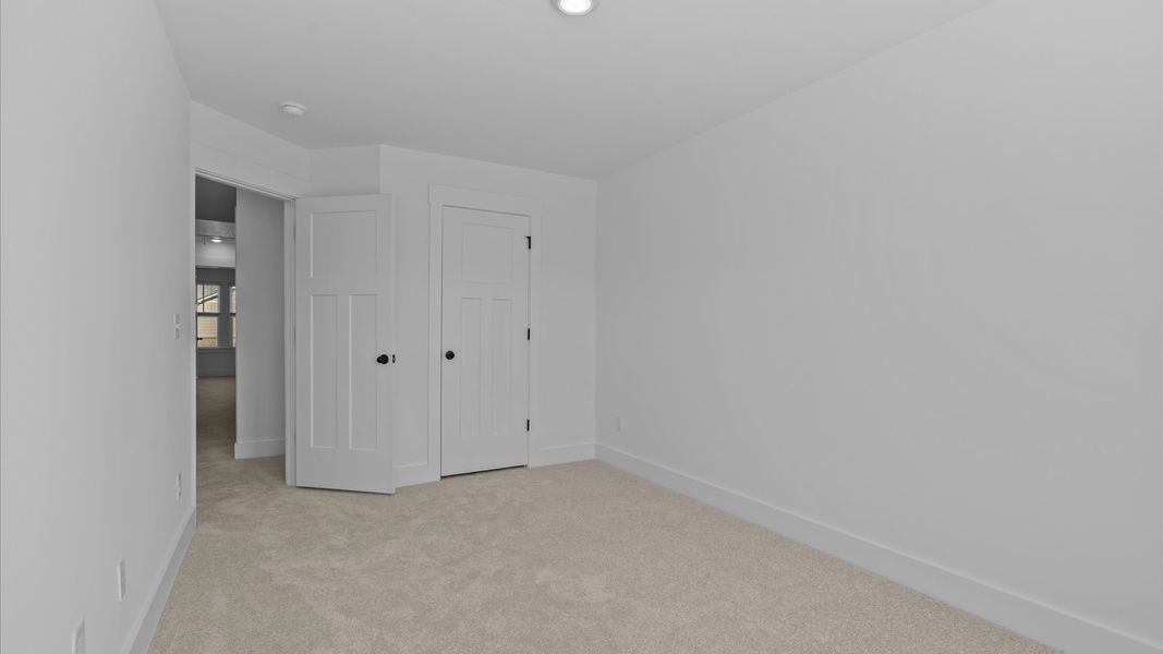 First-rate secondary bedroom with a spacious walk-in closet and elegant carpeted flooring