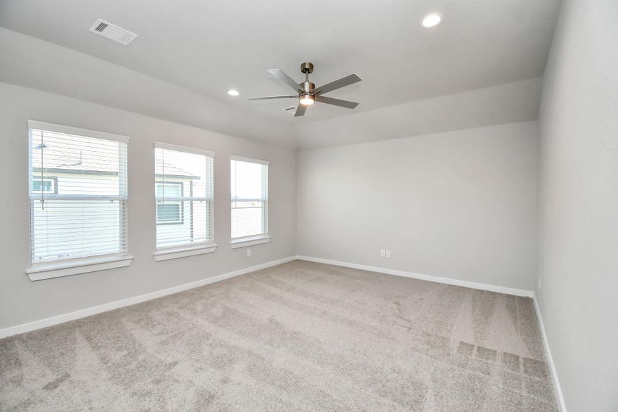 Ascend to relaxation in this fantastic game room! Ideal for both casual gatherings and adult gaming, it boasts plush carpet, lofty ceilings, custom paint, and ample windows for abundant natural light. Sample photo of completed home with similar floor plan. Actual colors and selections may vary.