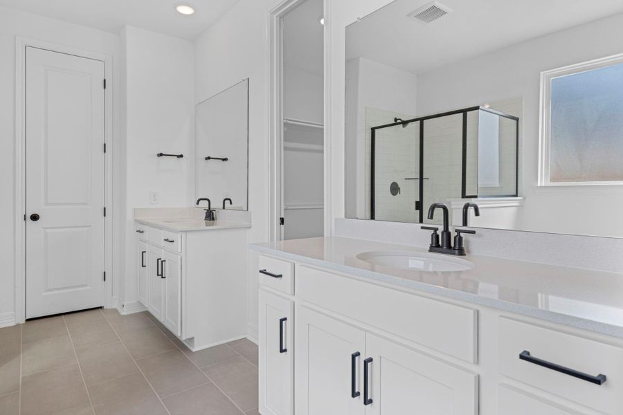 The en-suite bathroom offers a spa-like atmosphere with its elegant design, high end finishes, and tasteful lighting, creating a retreat within your own home. The en-suite bathroom offers a spa-like atmosphere with its elegant design, high end finishes, and tasteful lighting, creating a retreat within your own home.