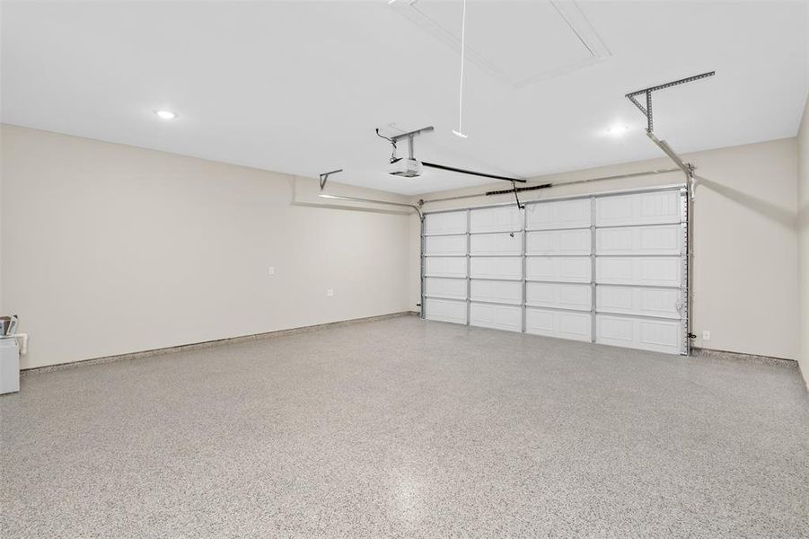 Garage featuring epoxy floors, baseboards, 8 ft tall garage door, 24 ft long garage made for long bed trucks