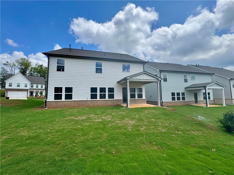 Front exterior of a new home in Eastlyn Crossing - Single Family, Flowery Branch, GA, highlighting curb appeal (Image 22). Front exterior of a new home in Eastlyn Crossing - Single Family, Flowery Branch, GA, highlighting curb appeal (Image 22).