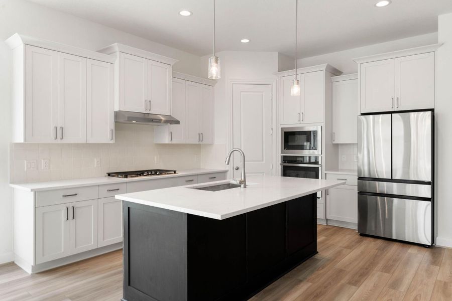 The kitchen has beautiful cabinets, gas cooktop, an island, and stainless steel appliances that will make cooking enjoyable.