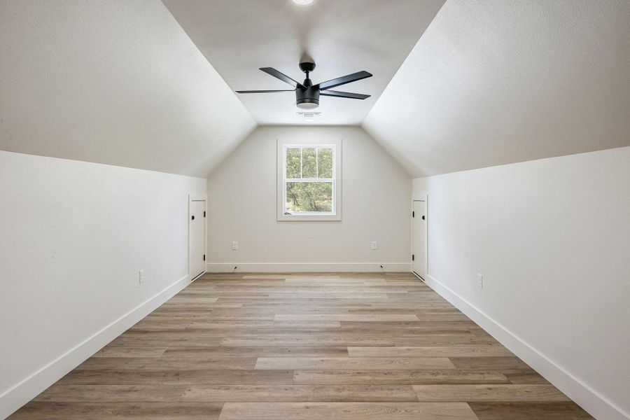 Large, finished flex space with dormer ceiling, recessed lighting, and window views—designed for flexible use as media, hobby, or private suite area. Large, finished flex space with dormer ceiling, recessed lighting, and window views—designed for flexible use as media, hobby, or private suite area.