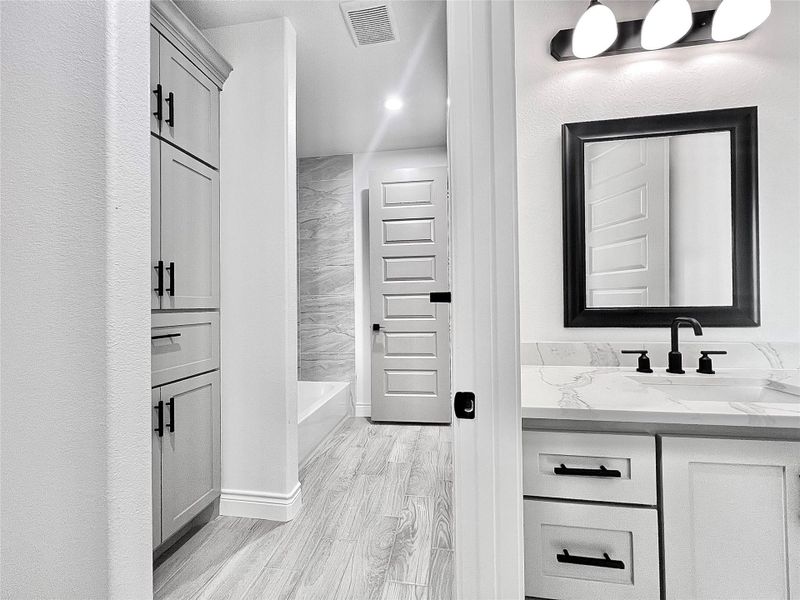 2nd. Bedrooms private sink vanity while sharing Shower/Tub and Commode with 3rd. Bedroom.