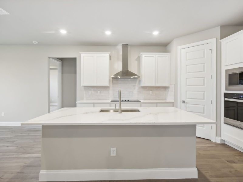 Kitchen in the Coral floorplan at 6398 NW Sweetwood Dr