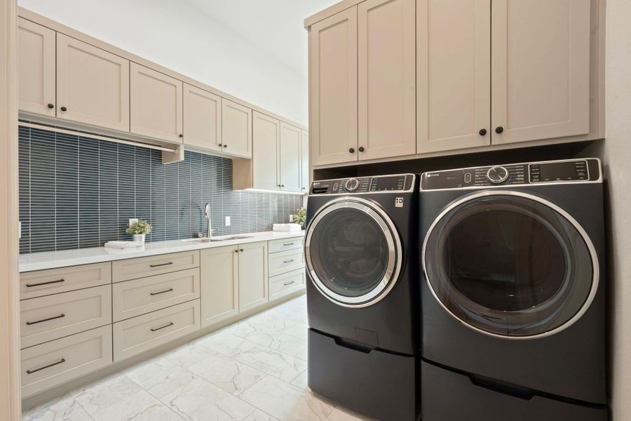 Huge Utility room with washer/dryer, sink and tons of storage.