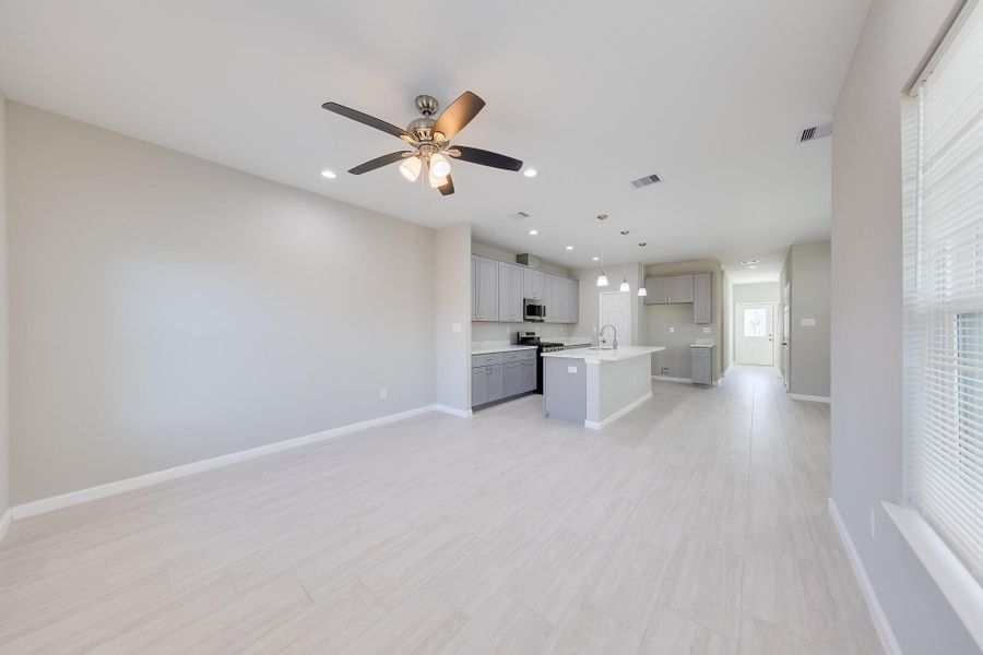 The seamless open-concept first floor connects living and dining areas, providing a spacious and versatile layout for modern lifestyles.