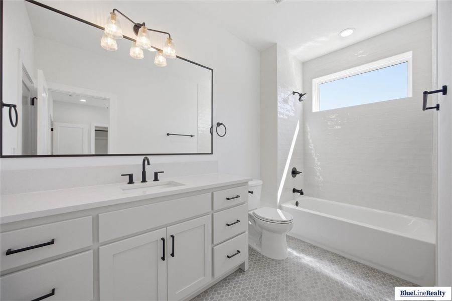 Bathroom with vanity,  shower combination, and recessed lighting