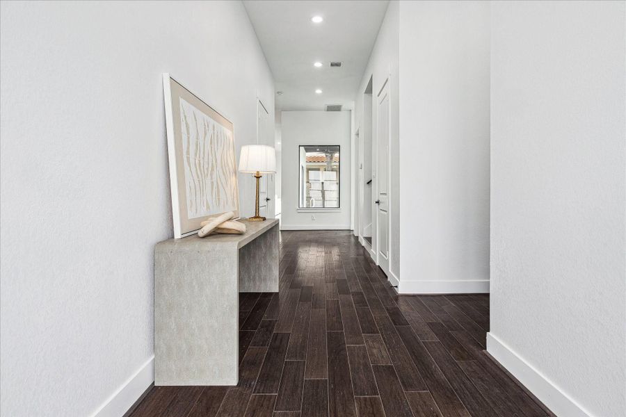 A stunning 11' entry welcomes you with soaring ceilings, abundant natural light, and refined architectural details that immediately set the tone for the home’s sophistication.