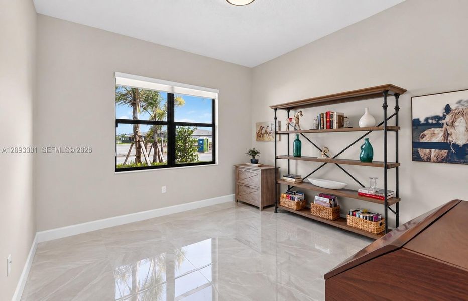 Interior room featuring high-gloss tile flooring, neutral wall paint, and a single-pane window with a black frame Interior room featuring high-gloss tile flooring, neutral wall paint, and a single-pane window with a black frame