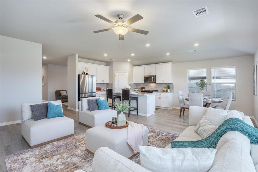 Living area with ceiling fan, light wood-style flooring, and recessed lighting Living area with ceiling fan, light wood-style flooring, and recessed lighting