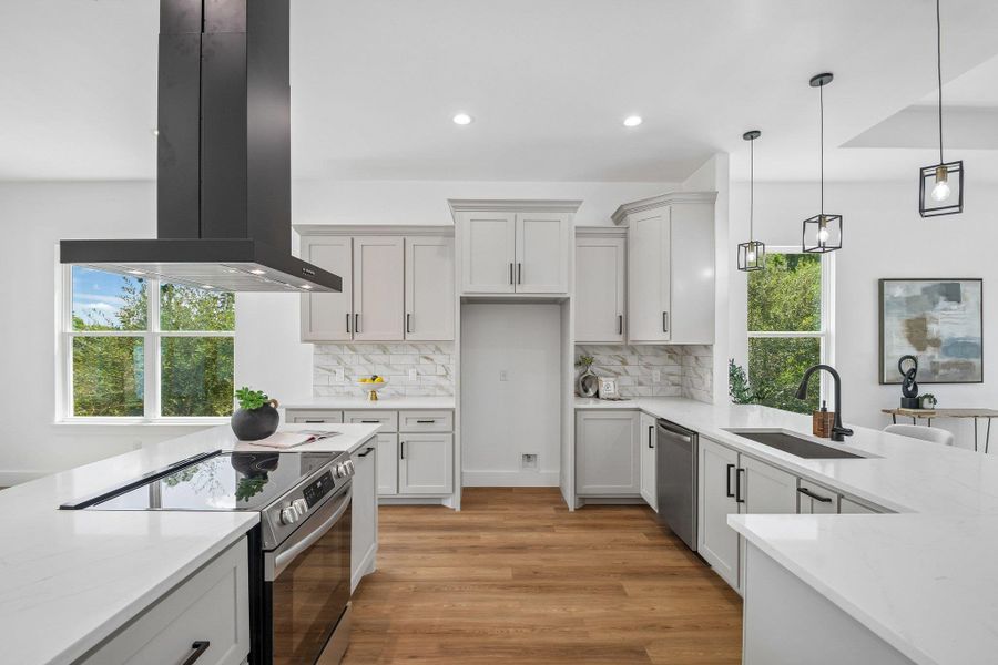 Crisp white cabinetry paired with stone countertops defines this open, contemporary culinary space. Crisp white cabinetry paired with stone countertops defines this open, contemporary culinary space.