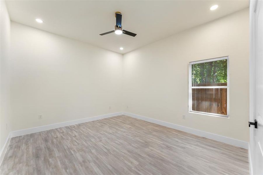 Spare room featuring ceiling fan, light wood finished floors, and recessed lighting