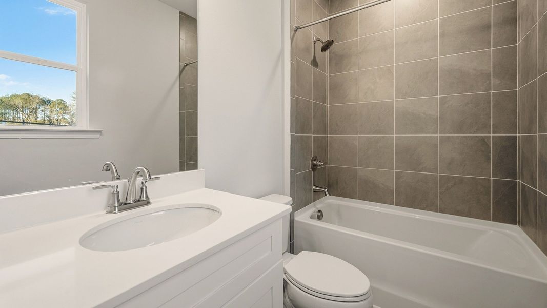 Secondary bathroom with single vanity and tiled shower Secondary bathroom with single vanity and tiled shower