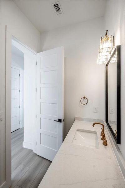 Bathroom with light wood finished floors and vanity