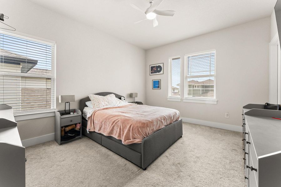 The third bedroom features a walk-in closet, ceiling fan with light fixture, and a TV mount.