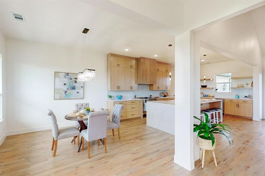 Dining area with light hardwood / wood-style flooring