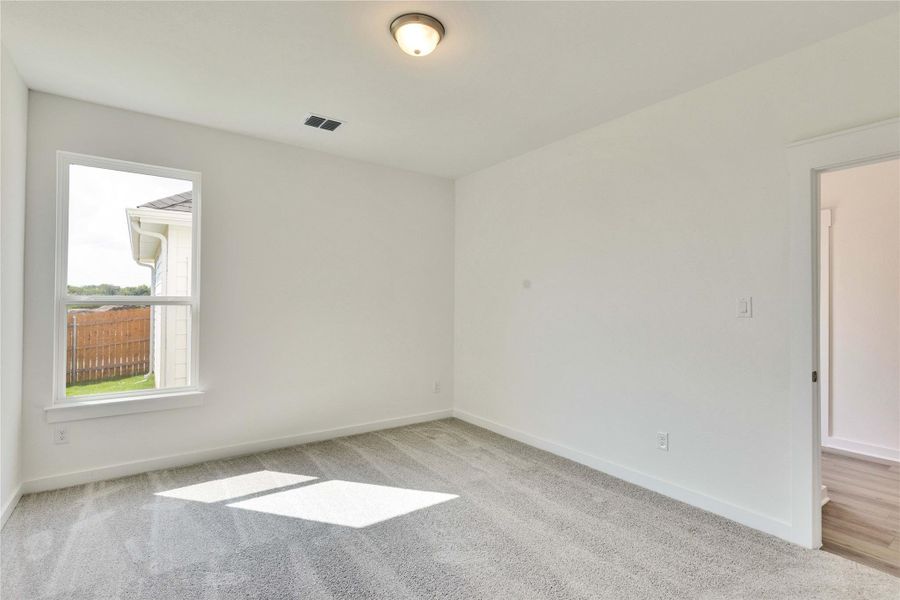 Empty room with carpet and baseboards
