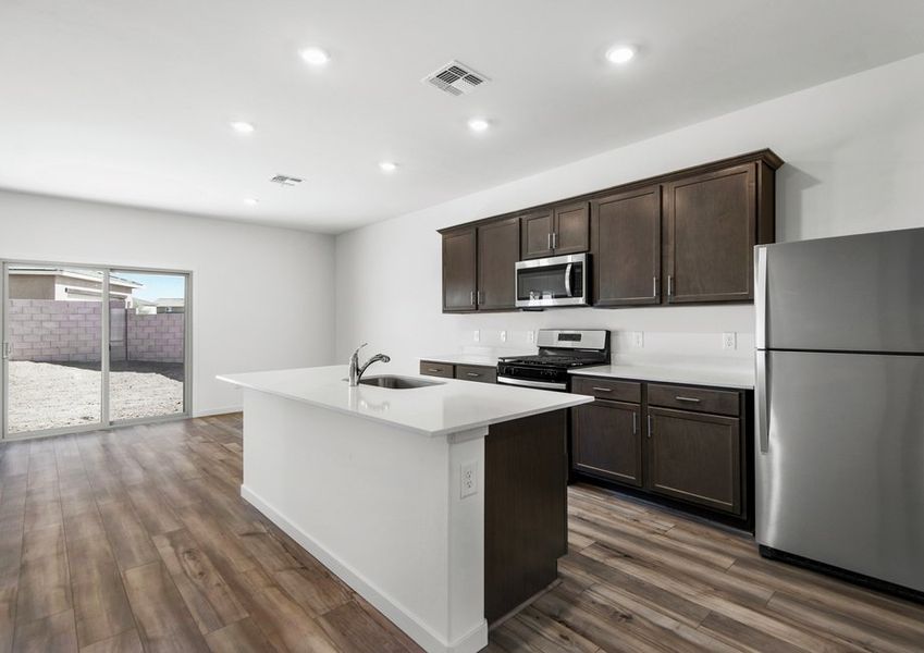 Enjoy stunning granite countertops and designer wood cabinetry in the kitchen.