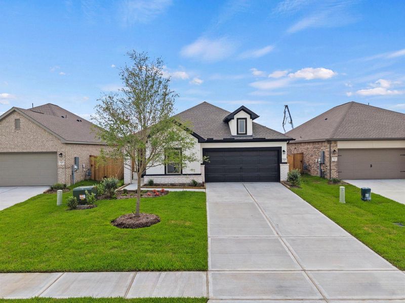 Front exterior of a new home in Windrose Green, Angleton, TX, highlighting curb appeal (Image 20).