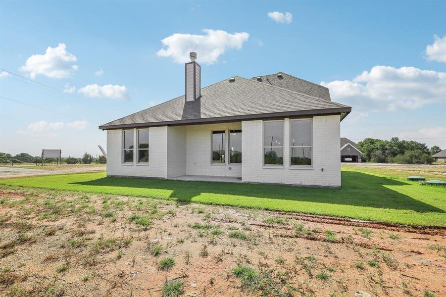 Front of property featuring a garage and a front lawn