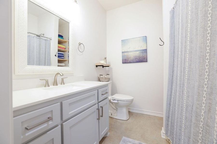 Full bath with vanity and a shower with curtain