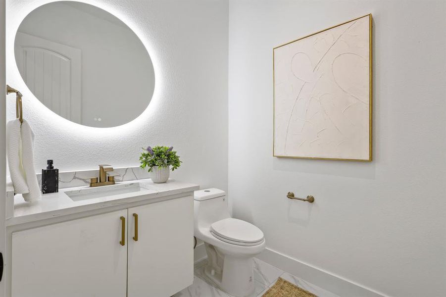 Bathroom with tile patterned flooring, vanity, and toilet