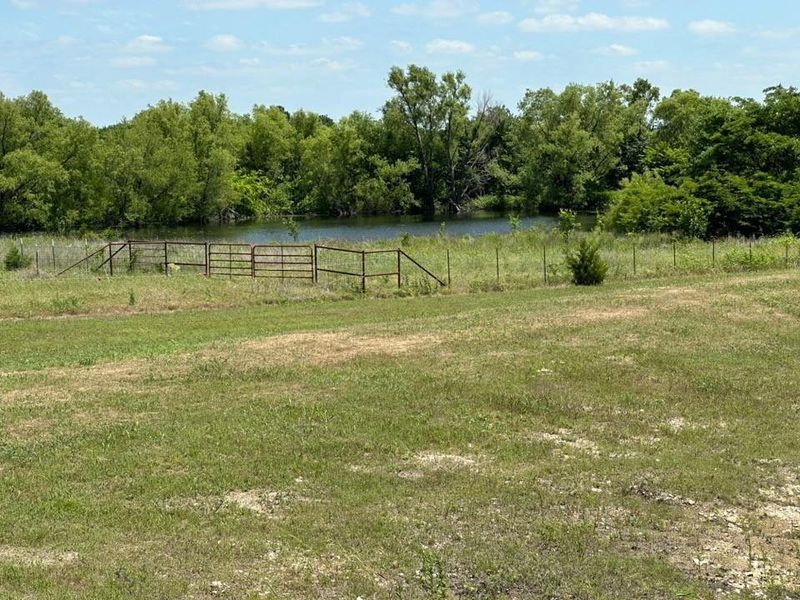 Expansive grassy terrain with a bordering body of water