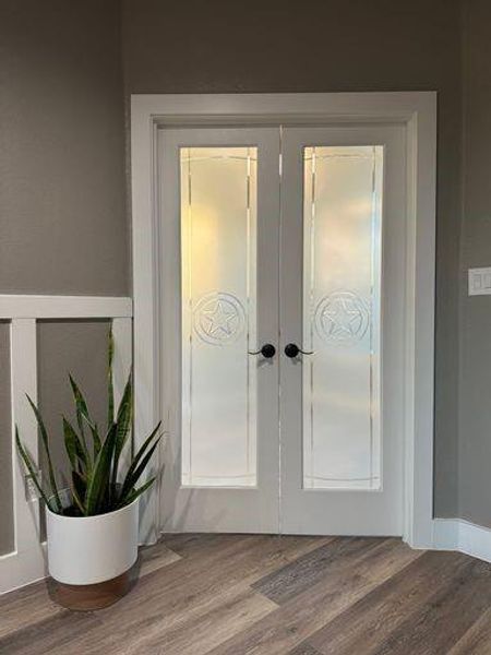 Interior details with hardwood / wood-style floors and french doors