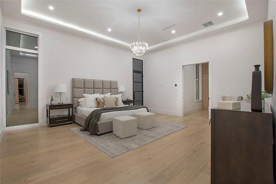 Bedroom with an inviting chandelier and light hardwood / wood-style flooring