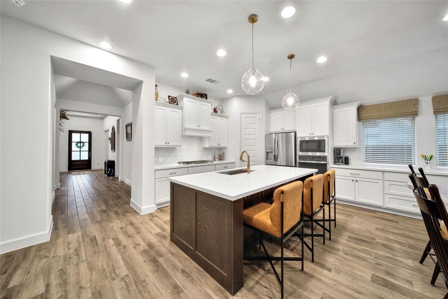 Bar-height counter seating at the kitchen island creates the perfect spot for casual meals. Beneath the island is extra storage for essential items.