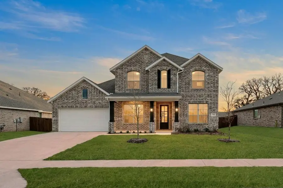Front exterior of a new home in Westside Preserve, Midlothian, TX, highlighting curb appeal (Image 2).