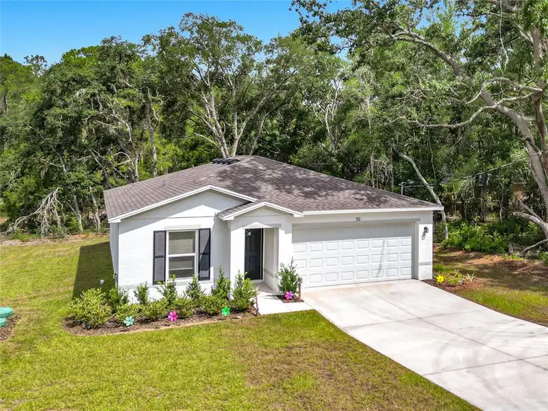 Front exterior of a new home in The Collection at Ocklawaha, Ocklawaha, FL, highlighting curb appeal (Image 25). Front exterior of a new home in The Collection at Ocklawaha, Ocklawaha, FL, highlighting curb appeal (Image 25).