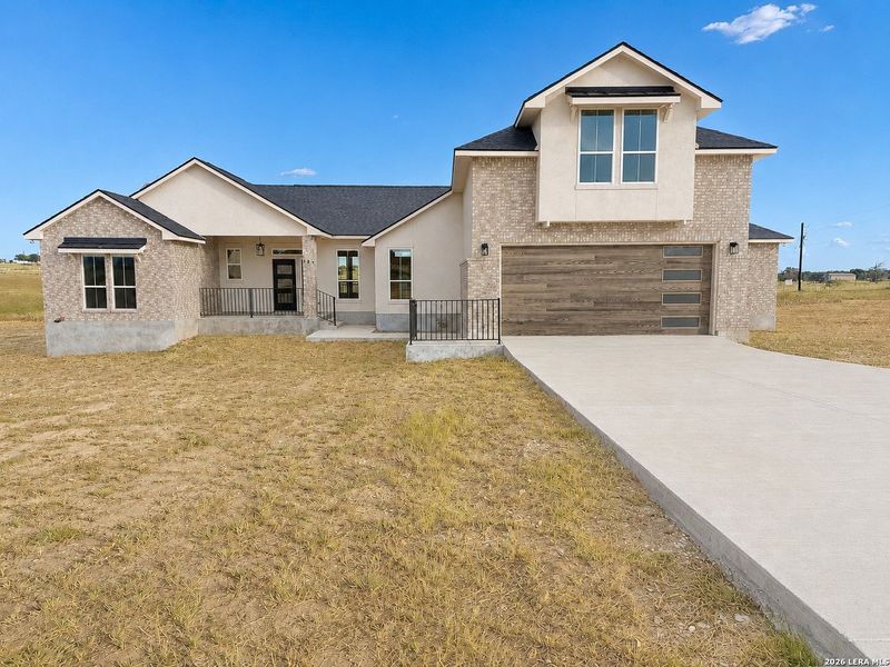 Front exterior of a new home in , La Vernia, TX, highlighting curb appeal (Image 25).