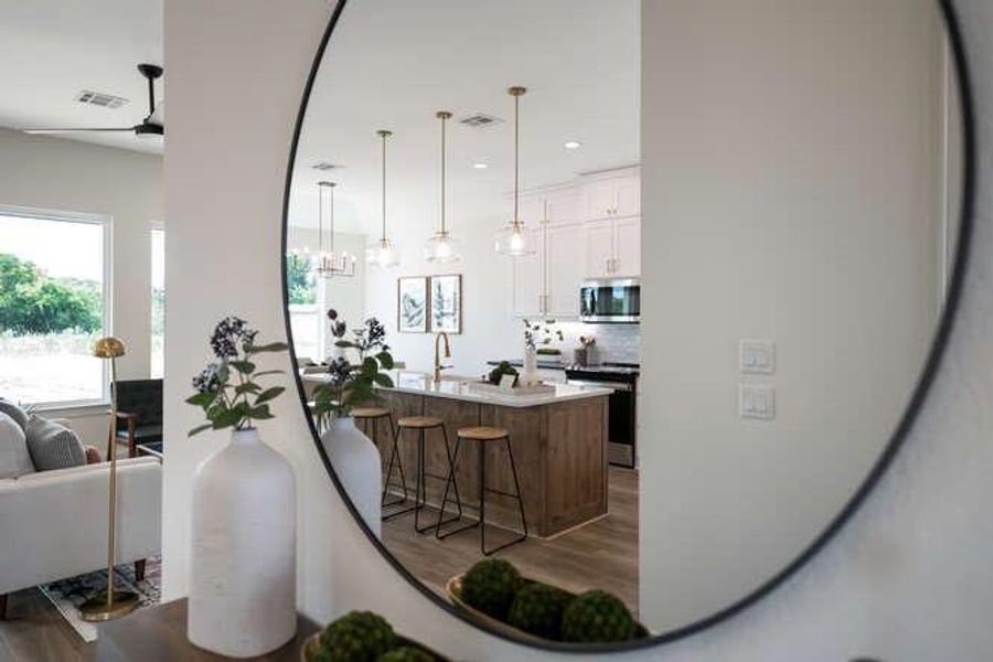 Kitchen featuring white cabinets, lighting, and island Kitchen featuring white cabinets, lighting, and island