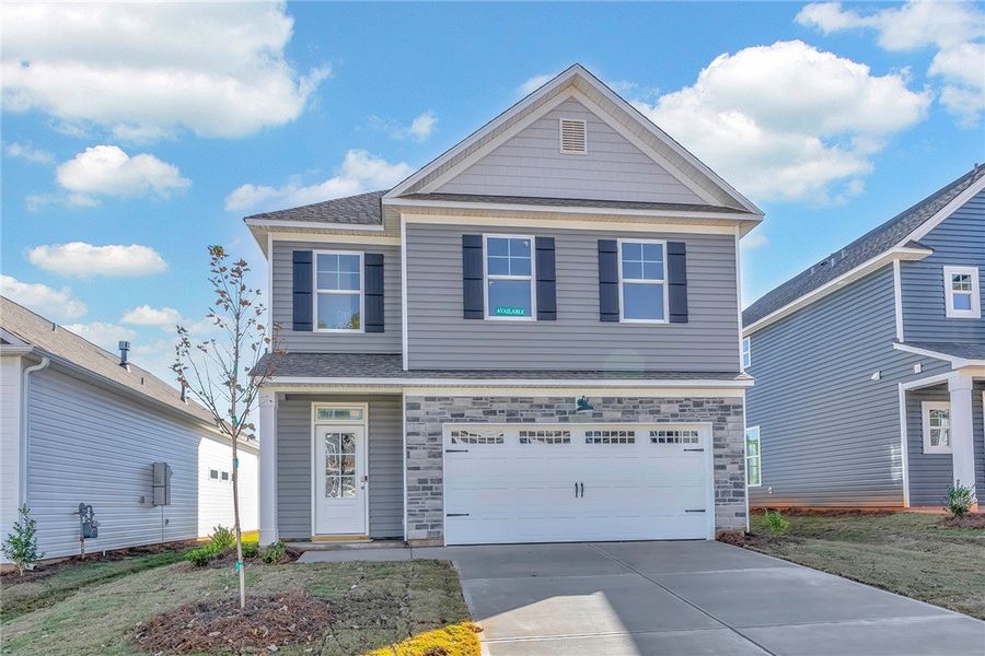 Front exterior of a new home in Brownstone Park, Easley, SC, highlighting curb appeal (Image 1).