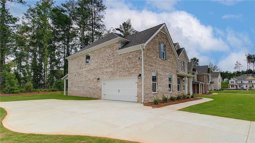 Front exterior of a new home in Trinity Park, McDonough, GA, highlighting curb appeal (Image 20).