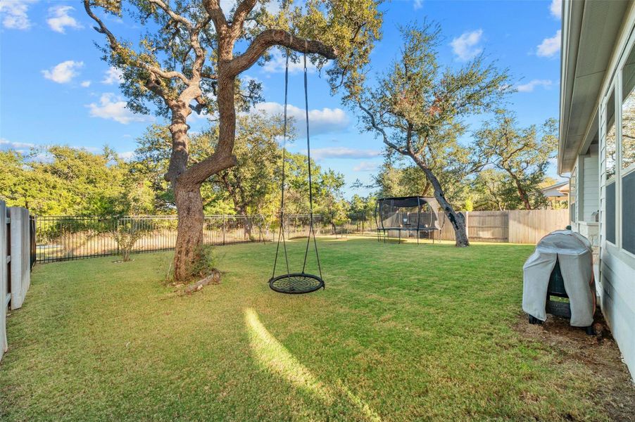 The backyard comes fenced-in with tall wood privacy fencing on the sides and wrought iron fencing along the back side so you can enjoy the lovely views.