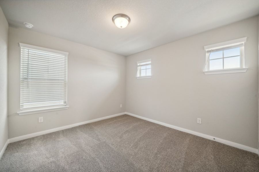 Guest bedroom in the Matador floorplan in the Meritage Homes community.