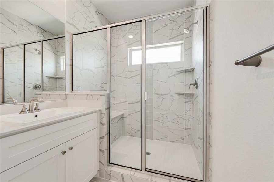 Bathroom featuring vanity, an enclosed shower, and tile patterned floors