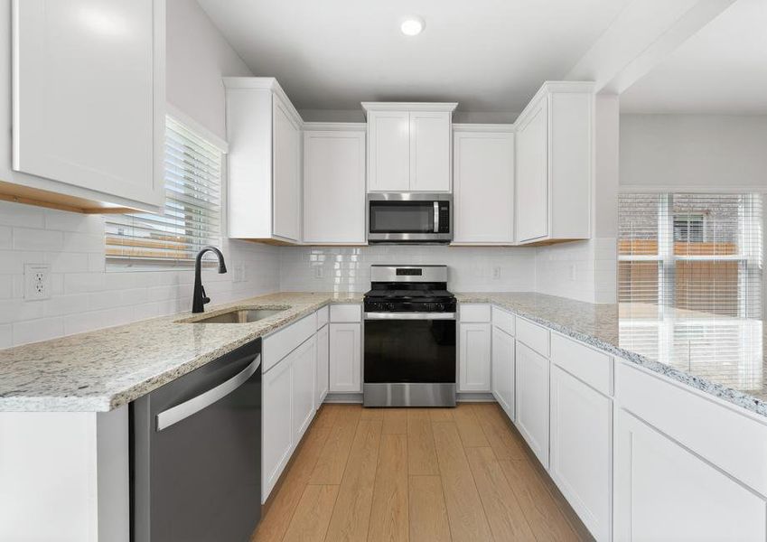 The kitchen of the Piper has white wood cabinets.